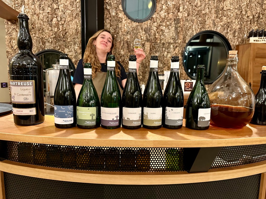 Julie of Famile Mousse, showing off the range of champagnes.